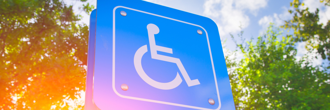 The First Time I Used My Disabled Parking Placard at College Parking for disability persons sign with green and sun light background.