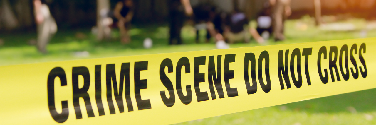 Dear Media: Stop Blaming Autism for Acts of Mass Violence Crime scene tape and blurred law enforcement team.