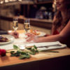 couple having a romantic dinner in a restaurant with a rose lying on the table
