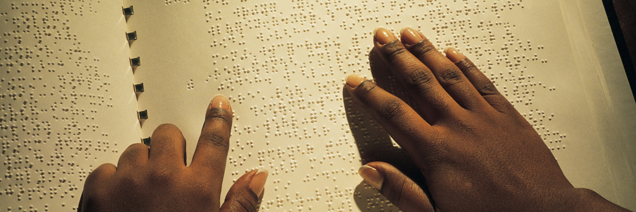 Creating Opportunities for Blind Students in Higher Education Hands of Black person reading Braille book.
