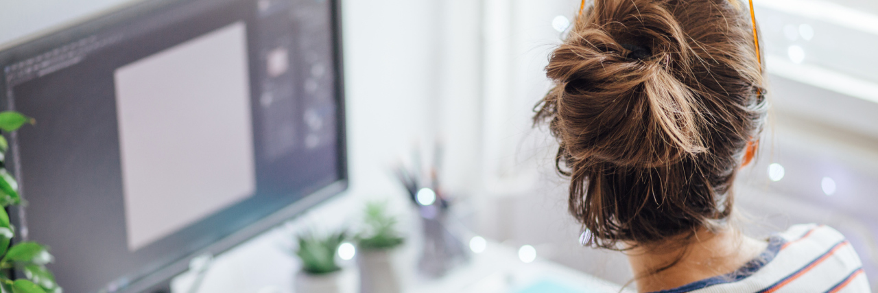 My Fears About Starting a New Job as Someone With Chronic Illness woman working at her desk