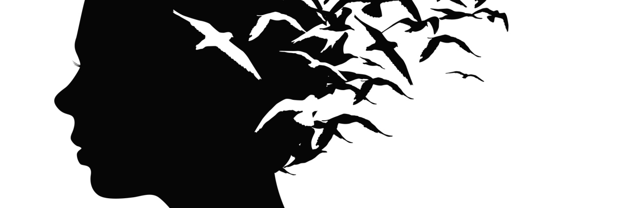 Black silhouette portrait of a girl with birds flying from her head