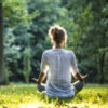 Woman meditating in the park.