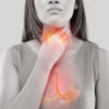 black and white photo of a woman holding her throat with her esophagus lit up red