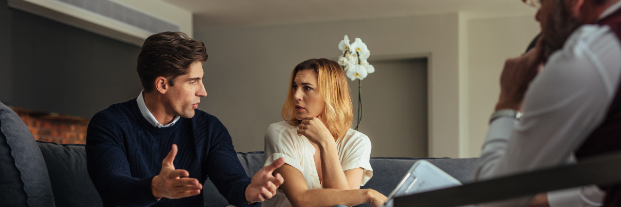 Couple arguing during therapy session with psychologist