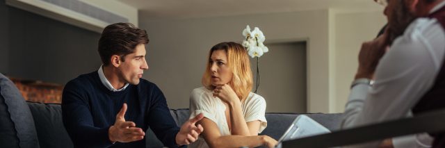 Couple arguing during therapy session with psychologist