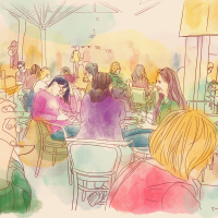 A group of people sit in a cafe and talk. The colors in this photo present a warm feeling.