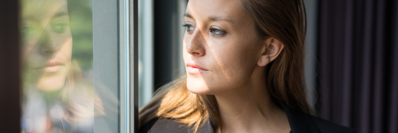 Why Chronic Illness Is Not Your Fault woman looking out the window of a train