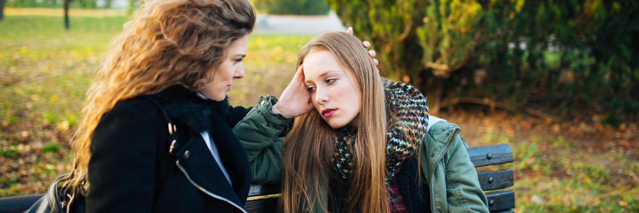 Why Friends Are Important for Combating Loneliness of Chronic Illness two friends talking on a park bench