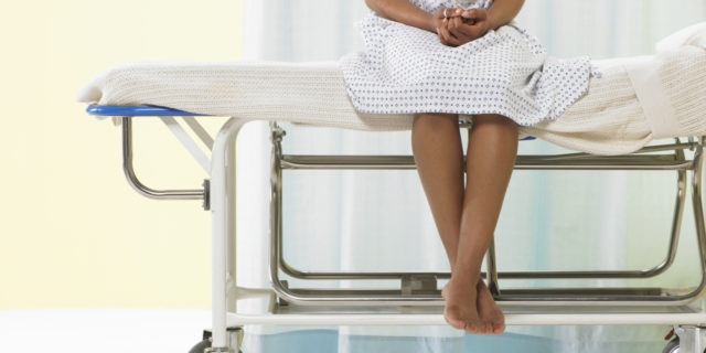 Why Being Labeled 'Medically Complex' Is a Challenge Female patient sitting on gurney in hospital gown