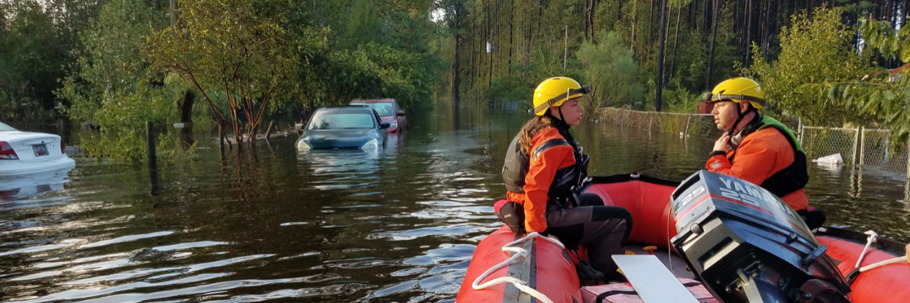 Two rescuers sit in a red raft in flood waters in North Carolina after hurricane Florence.