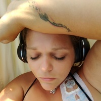 A photo og the writer showing a picture of her tattoo on her arm that reads, "This too shall pass."