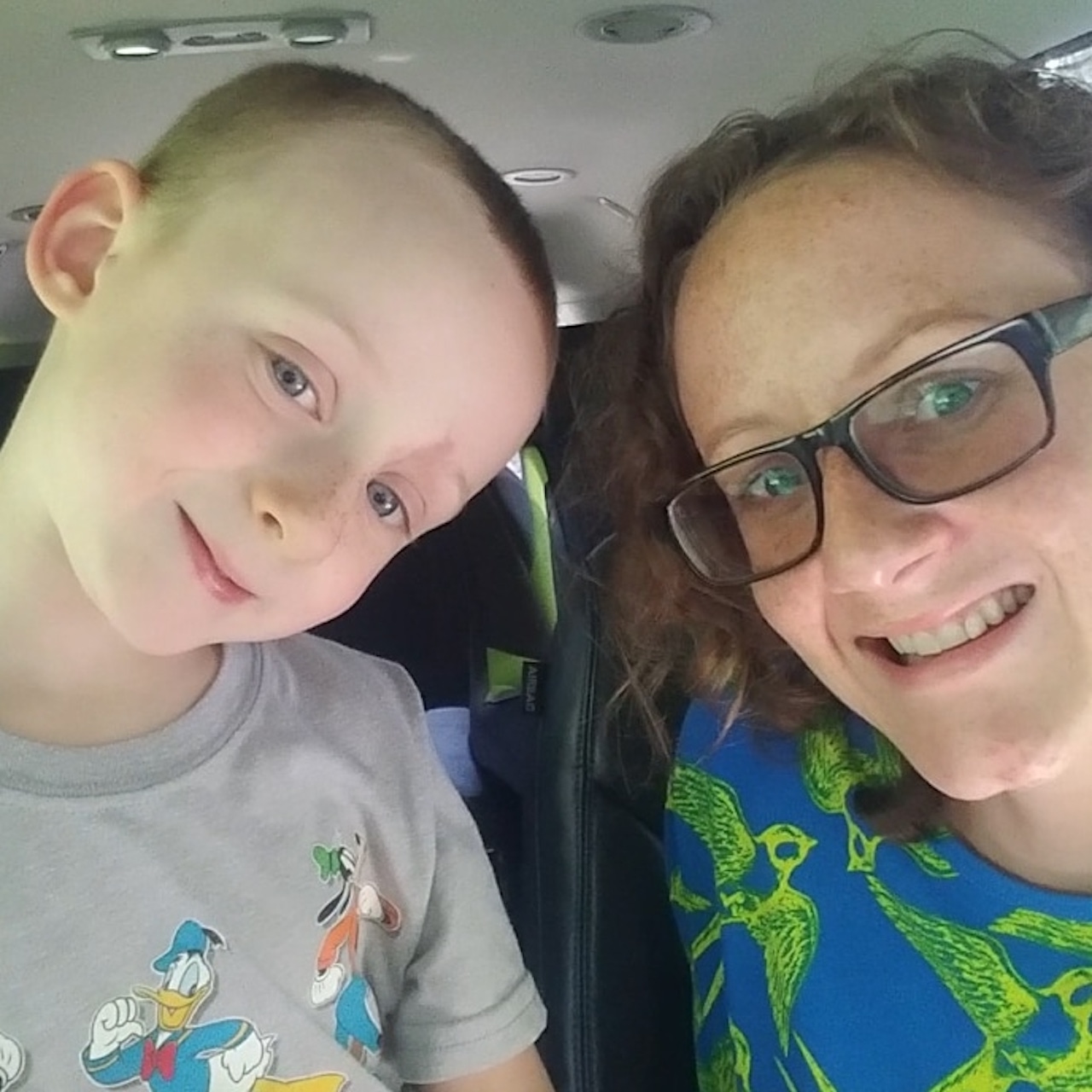 mom and son on the autism spectrum take a selfie in the car
