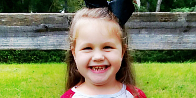 Why We Take the NICU Journey One Moment at a Time Little girl smiling at camera wearing a shirt that says, "Ain't no mama like the one I got."