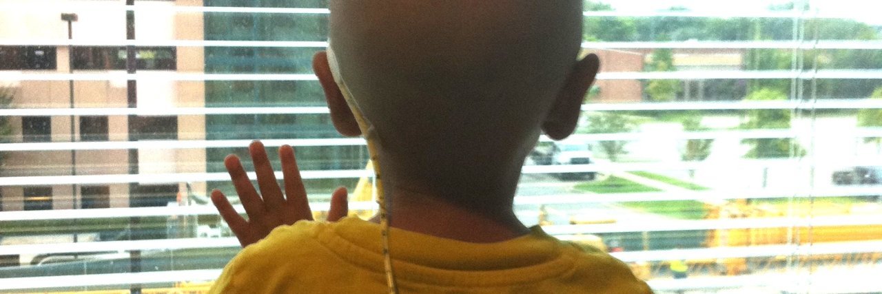 The Choices a Parent Faces When Their Child Has Cancer A boy looking out a hospital window