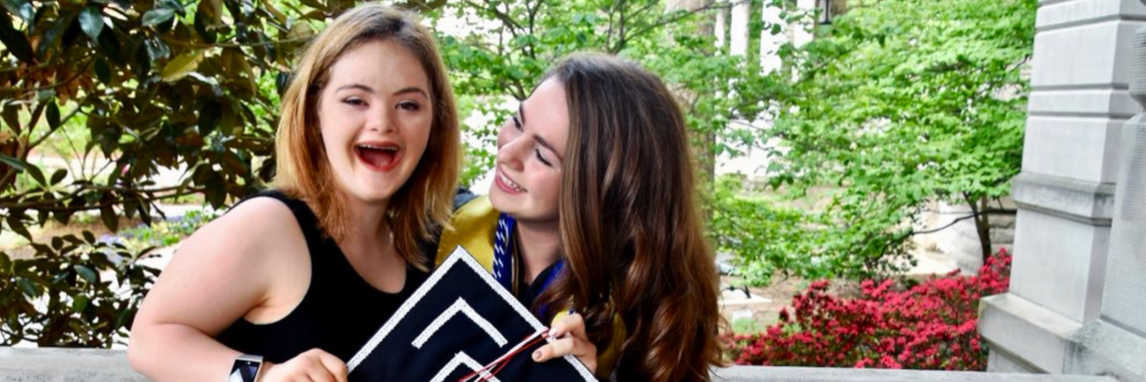 Woman Says Sister Was Denied From Sororities Because of Down Syndrome AnnCatherine and Lillie Heigl holding Lillie's graduation cap.