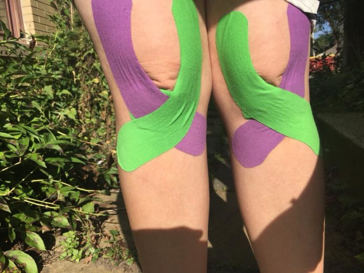 Green and purple tape over knees