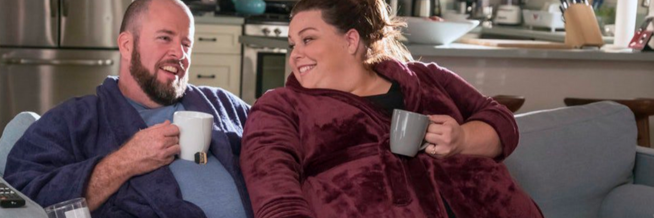 'This Is Us' Reveals Kate Pearson Has PCOS Toby and Kate lounging on a sofa drinking out of mugs.