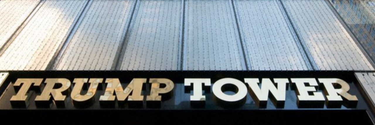 Trump Has a History of Disregarding Disabled People Outside sign for Trump Tower