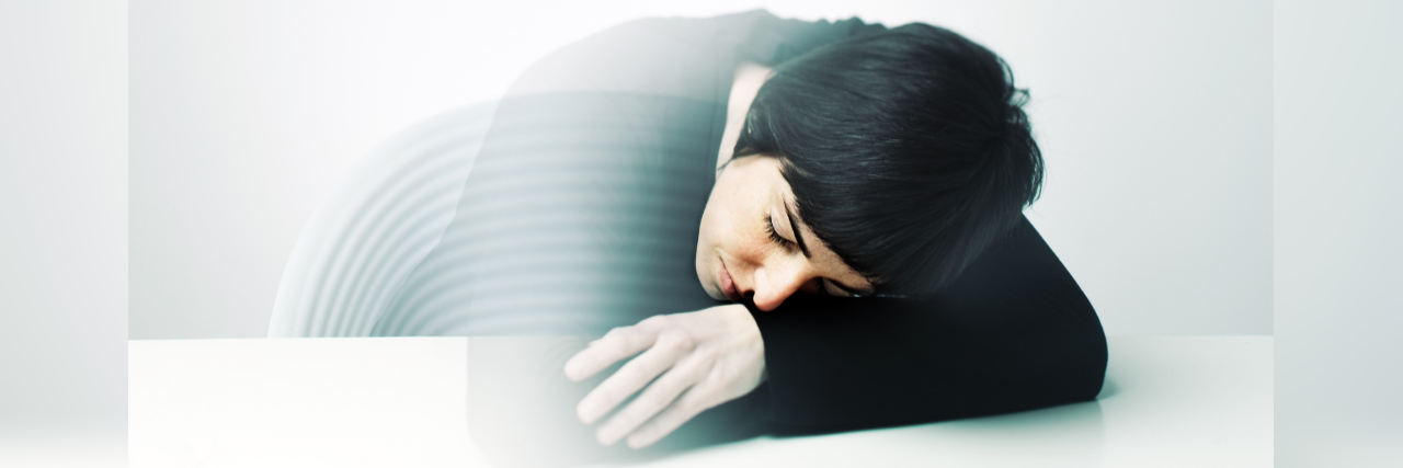 woman leaning on a desk with the image of her fading out