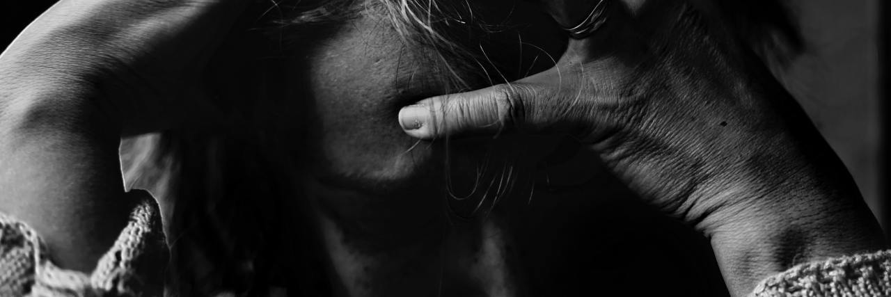 Choosing to Live, Not Die by Suicide adult woman with hands on head upset