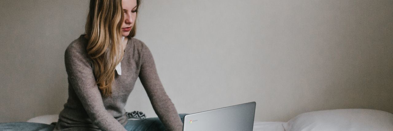 What You Shouldn’t Say to Someone With Depression young woman sitting on bed typing on laptop
