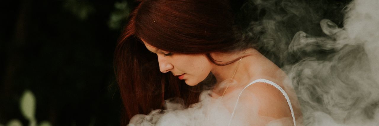 Not Wanting to Cover Self-Harm Scars redhead young woman looking down while smoke covers her body
