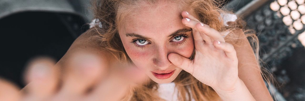 A Letter to the Relationships I've Sabotaged A woman looking up