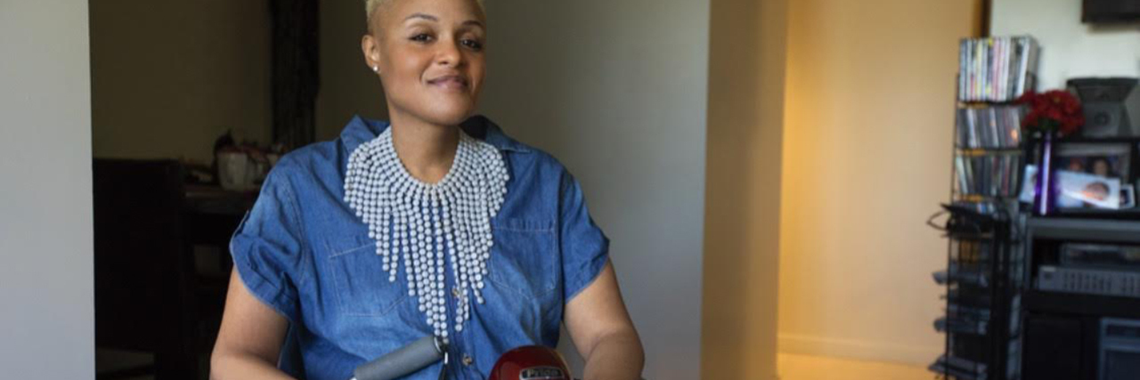 How to Travel With Muscular Dystrophy Keisha Greaves sitting in her scooter.