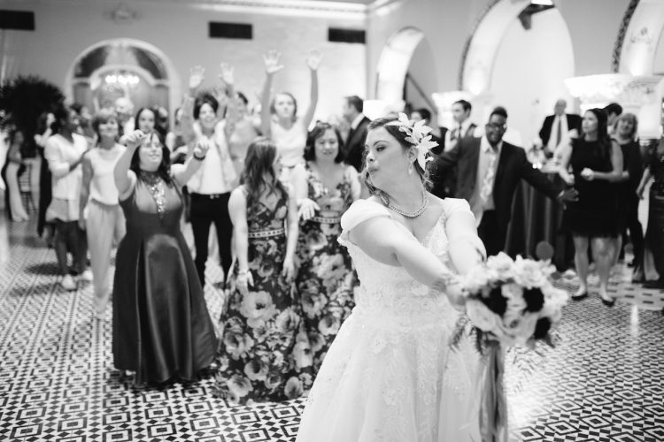 black and white image of Cristina throwing her bouquet