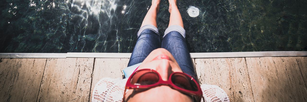 5 Things to Remember When Illness Makes Self-Care a Full-Time Job A picture of a woman putting her feet in some water.