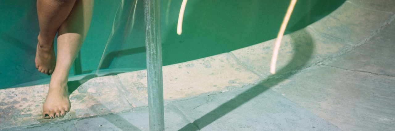 How to Manage ‘Out-Of-The-Blue’ Anxiety close up of woman's legs climbing out of pool in muted colors
