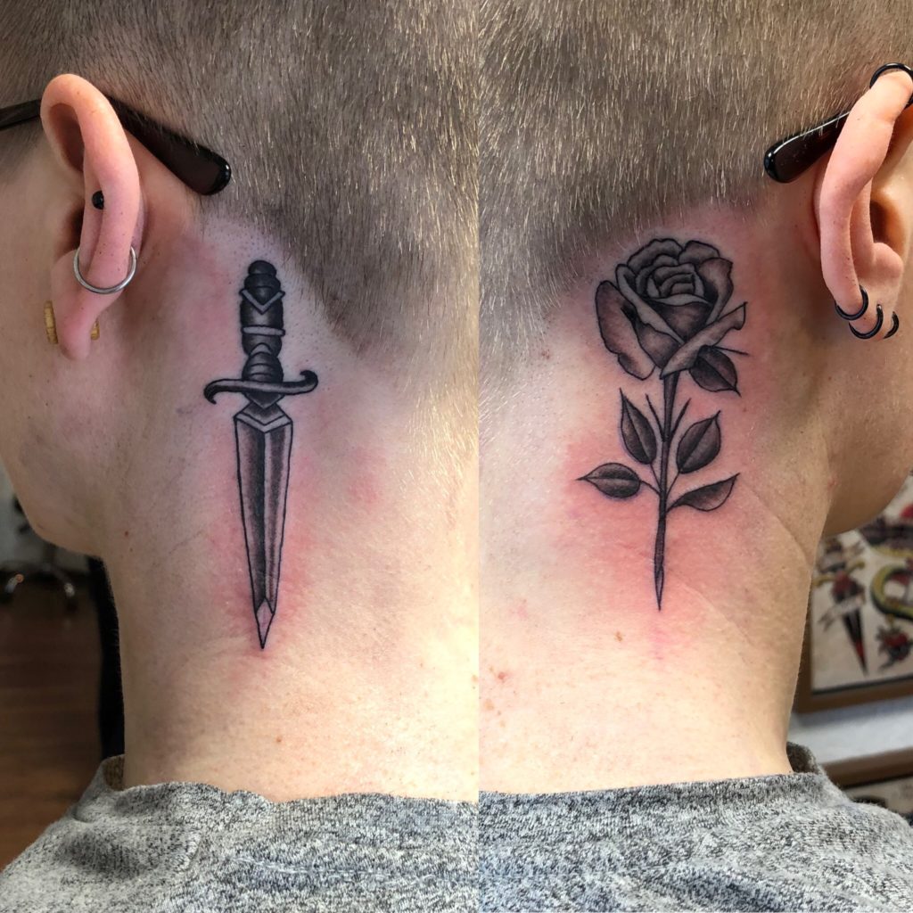two tattoos on either side of a person's neck, just behind the ear. one is a sword, the other is a rose, both in black ink.