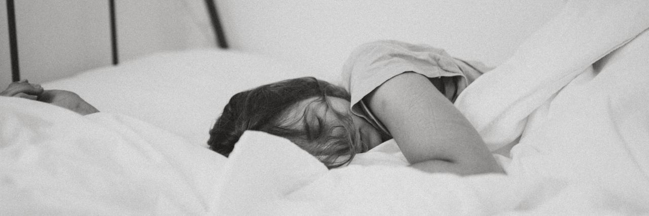 When You Ask People Living With Chronic Illness, 'What's Your Excuse?' A picture of a woman sleeping in a bed.