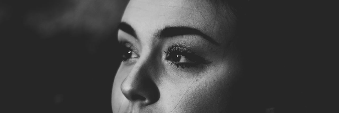 When You Believe Someone Can 'Save' You From Depression high contrast black and white photo of woman looking off-camera with serious expression