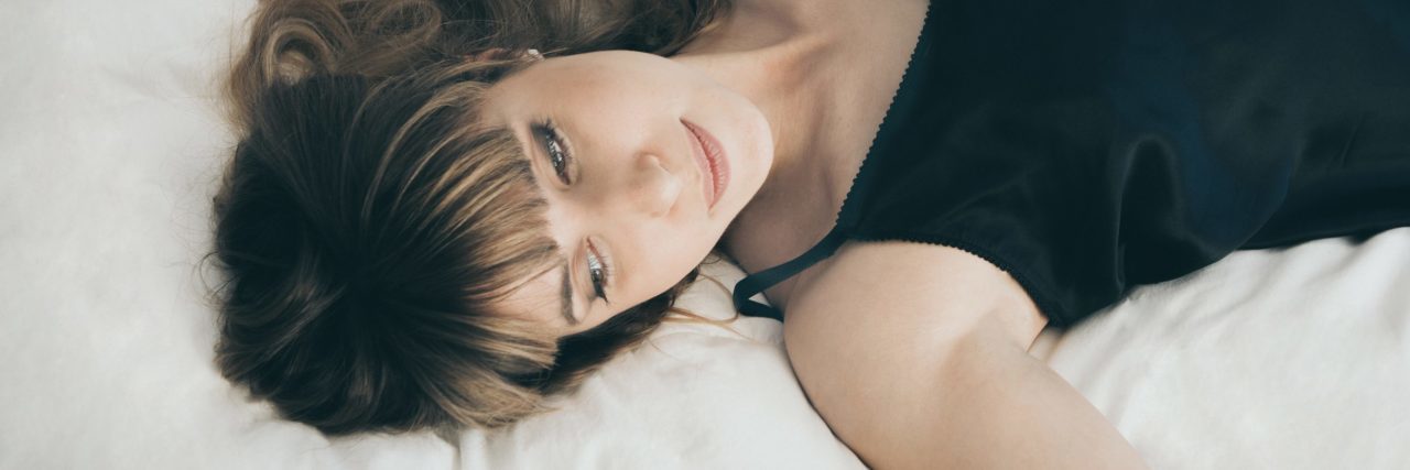 woman relaxed lying on bed