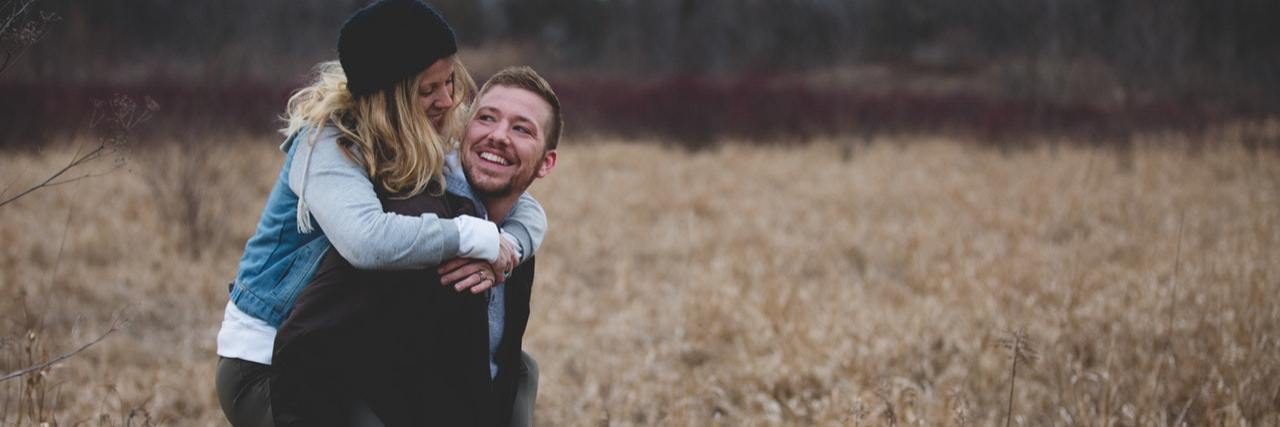 To My Boyfriend, From Your Girlfriend With Lupus man holding woman piggyback in field