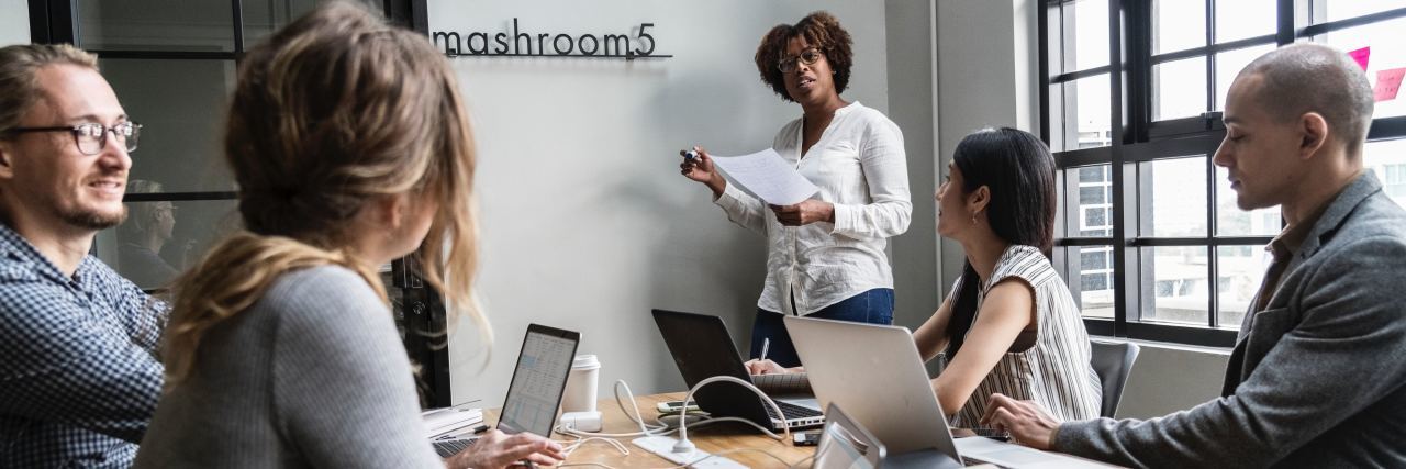 Why Fear Keeps Me From Calling in Sick for My Fibromyalgia A picture of people in a meeting room.