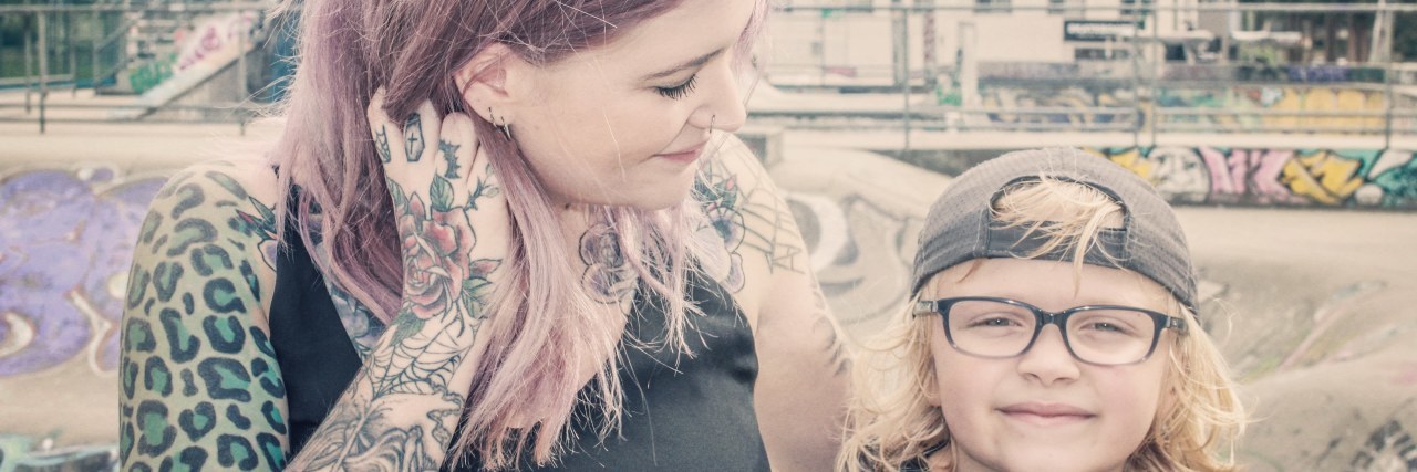 What It's Like to Be a Single Mom With Rheumatoid Arthritis the author standing outside with her son and smiling at him