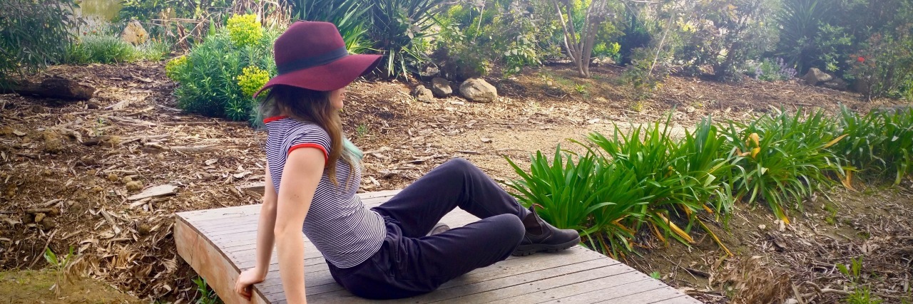 When People Doubt Your Abilities Due to Fibromyalgia woman sitting on bridge in garden