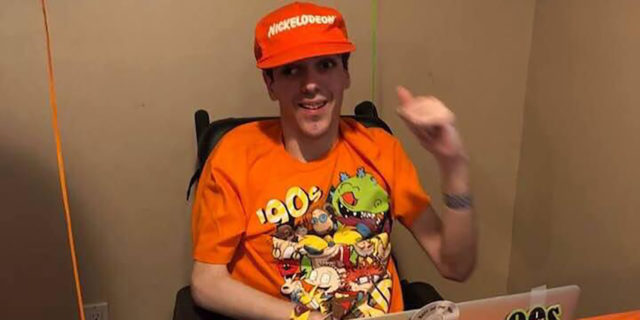 How Podcasting With a Disability Has Helped Me DJ Bob podcasting wearing an orange hat and Nickelodeon t-shirt.