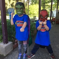 The author's two sons in superhero costumes and masks