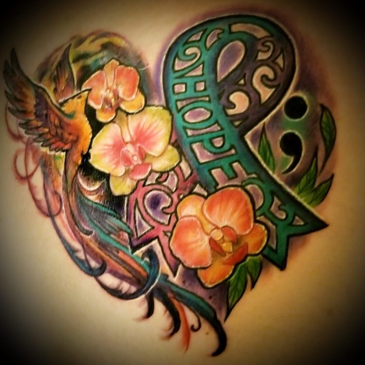 heart shaped tattoo made out of flowers, awareness ribbons and phoenix