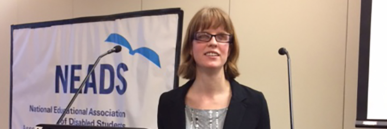 Many People With Disabilities Can't 'Unplug' Chelsea at a podium giving a presentation.