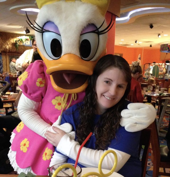 Woman with long brown hair and Daisy Duck at Disney Land