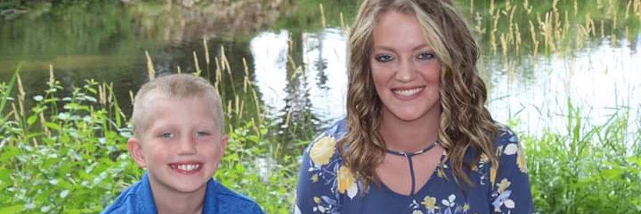 I Don't Care What People Think About My Son on the Autism Spec Son and mother smiling at camera with lake behind them