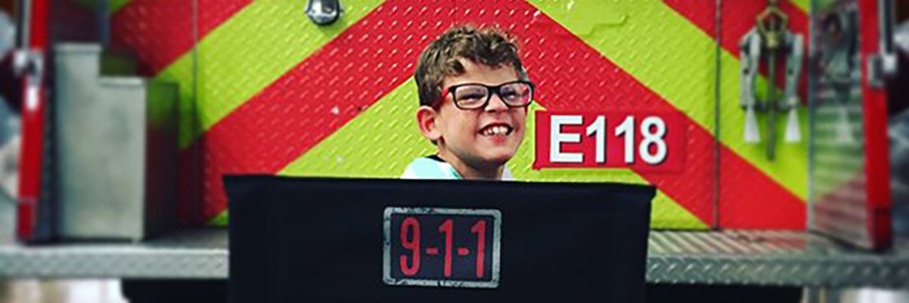 TV Show '9-1-1' Includes Character With Cerebral Palsy Gavin McHugh poses with a fire truck on the set of the TV show 911.