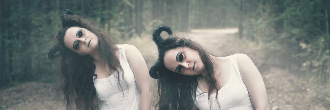 Cerebral Palsy and Psoriatic Arthritis Two twins demons with horns in forest.