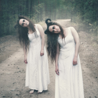 Two twins demons with horns in forest.