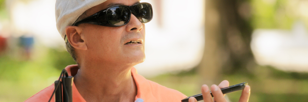Addressing Society's Fear of Disability Blind Man Talking on Mobile Phone.